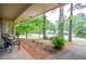 Inviting covered porch offers a relaxing outdoor space with views of the landscaped front yard at 1438 Ridgeland Sw Ct, Lilburn, GA 30047