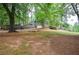 Spacious front yard with mature trees, offering a serene and inviting atmosphere for this lovely home at 1438 Ridgeland Sw Ct, Lilburn, GA 30047