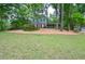 Charming home with a lush front lawn, mature trees, and well-maintained landscaping, enhancing its curb appeal at 1438 Ridgeland Sw Ct, Lilburn, GA 30047