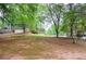 Large front yard provides a picturesque view, showcasing the home's curb appeal and surrounding greenery at 1438 Ridgeland Sw Ct, Lilburn, GA 30047