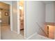 Hallway view to bathroom with wood vanity and tile floor, connecting living spaces with neutral tones at 1438 Ridgeland Sw Ct, Lilburn, GA 30047