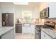 Kitchen with white cabinets, granite countertops, stainless steel appliances, and subway tile backsplash at 1438 Ridgeland Sw Ct, Lilburn, GA 30047