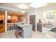 Kitchen with island seating, granite countertops, stainless steel appliances, and a view into the living room at 1438 Ridgeland Sw Ct, Lilburn, GA 30047