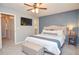 Bedroom with stylish accent wall, soft carpet, and a ceiling fan, creating a comfortable and appealing interior at 1438 Ridgeland Sw Ct, Lilburn, GA 30047