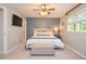 Bedroom features a stylish bed with a blue accent wall and a window for natural light at 1438 Ridgeland Sw Ct, Lilburn, GA 30047