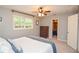 Bedroom with natural light from the window, dresser, and convenient closet access for organized storage at 1438 Ridgeland Sw Ct, Lilburn, GA 30047