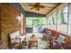 Relaxing screened porch features a brick wall and a seating area for entertaining or relaxing at 1438 Ridgeland Sw Ct, Lilburn, GA 30047