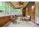 Beautiful screened porch with brick wall, seating, and a tropical rug for relaxation and enjoyment at 1438 Ridgeland Sw Ct, Lilburn, GA 30047