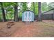 Charming backyard shed with double doors offers extra storage space at 1438 Ridgeland Sw Ct, Lilburn, GA 30047