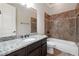 Bathroom featuring granite counters, tile flooring, and a soaking tub at 1655 Dawn Dr, Suwanee, GA 30024