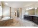 Large bathroom offering tub, separate shower, tile floors and double vanity at 1655 Dawn Dr, Suwanee, GA 30024