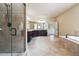 Bright bathroom features a double sink vanity, soaking tub, and a glass-enclosed shower at 1655 Dawn Dr, Suwanee, GA 30024