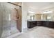 Bathroom featuring dual sinks, granite counters, and walk-in shower at 1655 Dawn Dr, Suwanee, GA 30024