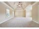 Large bedroom with high ceilings, plush carpet, and natural light at 1655 Dawn Dr, Suwanee, GA 30024
