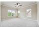Bedroom featuring plush carpet, ceiling fan, trim, and natural light at 1655 Dawn Dr, Suwanee, GA 30024