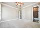 Bedroom with neutral walls, carpet, and access to bathroom at 1655 Dawn Dr, Suwanee, GA 30024