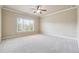 Bedroom with plush carpet, a ceiling fan, and a large window at 1655 Dawn Dr, Suwanee, GA 30024