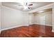 Bedroom with hardwood floors, base trim, neutral walls, and ceiling fan at 1655 Dawn Dr, Suwanee, GA 30024