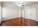Bedroom with hardwood floors, base trim, neutral walls, and ceiling fan at 1655 Dawn Dr, Suwanee, GA 30024