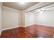 Bedroom with hardwood floors, base trim, neutral walls, and ceiling fan at 1655 Dawn Dr, Suwanee, GA 30024