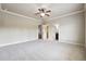 Open bedroom showcases ensuite bath, walk-in closet, neutral walls and plush carpeting at 1655 Dawn Dr, Suwanee, GA 30024
