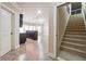 Entryway featuring staircase, neutral walls, and tile flooring leading to kitchen at 1655 Dawn Dr, Suwanee, GA 30024