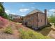 Large brick home with manicured landscaping, a deck, and multiple windows for natural light at 1655 Dawn Dr, Suwanee, GA 30024