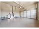 Spacious garage featuring epoxy flooring, built-in cabinets, and stairway to interior at 1655 Dawn Dr, Suwanee, GA 30024