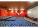 Red home theater room with projector, screen, elevated seating and premium speakers at 1655 Dawn Dr, Suwanee, GA 30024