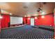 Home theater room with raised platforms, star-patterned carpet, projector, and screen at 1655 Dawn Dr, Suwanee, GA 30024