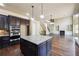 Open kitchen with stainless appliances and an island, connected to the spacious living area at 1655 Dawn Dr, Suwanee, GA 30024