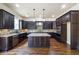 A gourmet kitchen with stainless steel appliances, granite countertops, and a center island at 1655 Dawn Dr, Suwanee, GA 30024