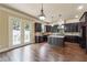 Well-equipped kitchen with dark wood cabinetry, stainless steel appliances, and access to the backyard at 1655 Dawn Dr, Suwanee, GA 30024