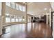 Bright living room adjacent to the kitchen, featuring tall windows and hardwood flooring at 1655 Dawn Dr, Suwanee, GA 30024