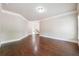 Empty living room featuring wood floors, white trim, and recessed lighting at 1655 Dawn Dr, Suwanee, GA 30024