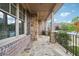 Covered front porch with stone columns, decorative lights and a stone floor with metal railing at 1655 Dawn Dr, Suwanee, GA 30024