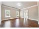 Open room boasting hardwood floors and three large windows, providing plenty of light at 1655 Dawn Dr, Suwanee, GA 30024
