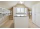 Spacious walk-in closet with custom shelving, an island, and large windows at 1655 Dawn Dr, Suwanee, GA 30024