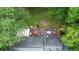 Aerial shot showcases the backyard with a deck, hot tub, and outdoor furniture, offering a relaxing retreat at 5500 Georgetown Sw Trce, Lilburn, GA 30047