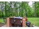 Cozy outdoor bar area with seating for two with lush greenery and a wooded backdrop at 5500 Georgetown Sw Trce, Lilburn, GA 30047