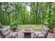 Relaxing backyard retreat featuring a fire pit area with comfortable seating on a wooden deck at 5500 Georgetown Sw Trce, Lilburn, GA 30047