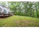 Expansive backyard features a deck, screened-in porch, and lush green space at 5500 Georgetown Sw Trce, Lilburn, GA 30047