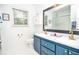 Bright bathroom featuring a large mirror, double sinks, and ample storage, providing style and functionality at 5500 Georgetown Sw Trce, Lilburn, GA 30047