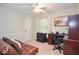 Well-lit bedroom offers a ceiling fan, plush carpet, and desk with office storage at 5500 Georgetown Sw Trce, Lilburn, GA 30047