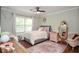 Cozy bedroom boasts natural light, hardwood floors, and comfortable furniture at 5500 Georgetown Sw Trce, Lilburn, GA 30047