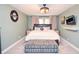 Stylish bedroom with a plush bed, upholstered bench, soft lighting, and decorative accents at 5500 Georgetown Sw Trce, Lilburn, GA 30047