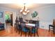 Elegant dining room with hardwood floors, stylish chandelier, and seating for six, perfect for Gathering gatherings at 5500 Georgetown Sw Trce, Lilburn, GA 30047