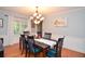 Cozy dining area with hardwood floors, and chandelier providing ample light for meals with Gathering and friends at 5500 Georgetown Sw Trce, Lilburn, GA 30047