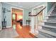 Charming entryway featuring hardwood floors, a staircase, and glimpses into a sunlit living room, creating a warm welcome at 5500 Georgetown Sw Trce, Lilburn, GA 30047