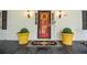 Close-up of a welcoming front door with potted plants and stylish decor at 5500 Georgetown Sw Trce, Lilburn, GA 30047
